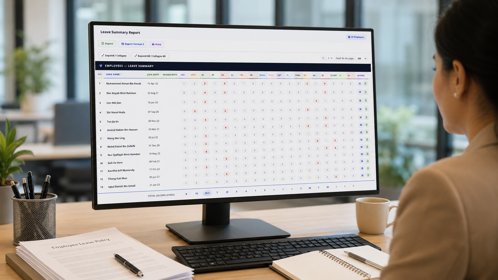 Malaysian HR manager reviewing attendance summary dashboard